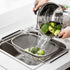 over-sink stainless steel drain rack in use, rinsing broccoli above sink for easy drainage
