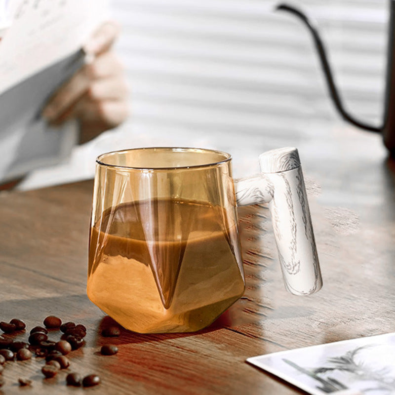Portable self-stirring coffee mug with a geometric design, showcasing its vibrant color and unique handle.