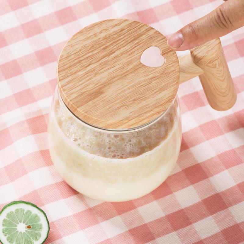 self stirring coffee mug with innovative lid and handle, filled with a blended beverage on a checkered tablecloth.