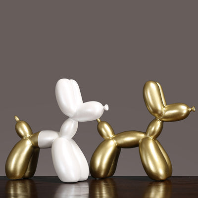 Luxury Decorative Wall Light and cut elegant balloon dog sculptures in white and gold on a stylish table.