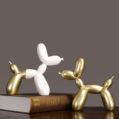 Luxury Decorative Wall Light and cut featuring elegant balloon dog sculptures in gold and white on a book