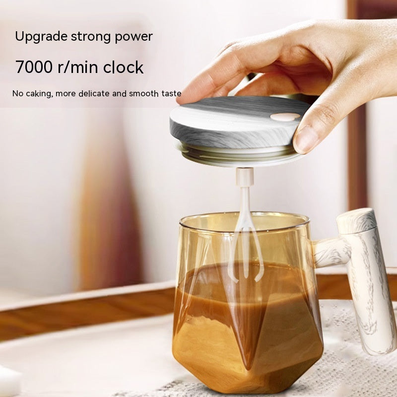 Portable self-stirring coffee mug in use, featuring an electric whisk and smooth coffee blending.