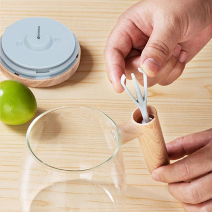 person using a self stirring coffee mug with a wooden handle and mixer in a modern kitchen setting